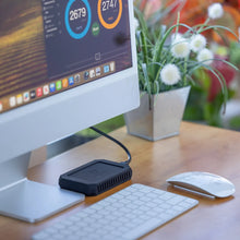 Load image into Gallery viewer, U34 Bolt portable SSD connected to a desktop workstation