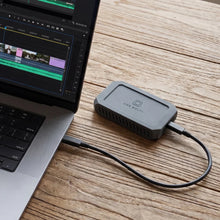 Load image into Gallery viewer, OYEN DIGITAL U35 Bolt+ portable SSD in a mobile workspace