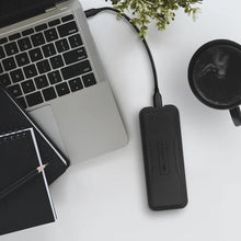 Load image into Gallery viewer, GLYPH Atom EV portable SSD connected beside a laptop