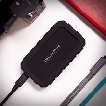 Load image into Gallery viewer, GLYPH Atom EX20 portable SSD in a creative workspace