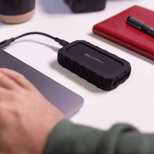 Load image into Gallery viewer, GLYPH Atom EX20 portable SSD connected beside a laptop