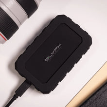 Load image into Gallery viewer, GLYPH Atom EX40 portable SSD beside professional camera equipment