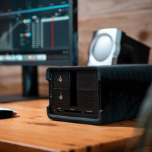 Load image into Gallery viewer, GLYPH Blackbox PRO RAID desktop drive beside an editing monitor