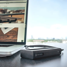 Load image into Gallery viewer, Oyen Digital Helix Dura SSD beside a laptop during mobile use