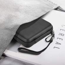 Load image into Gallery viewer, Closed black ProCase portable hard drive case with wrist strap sliding into a travel bag